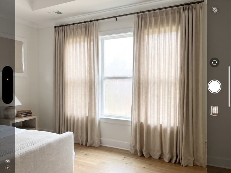 Curtains and drapery on a primary bedroom window in a new build in a modern subdivision in Cumming