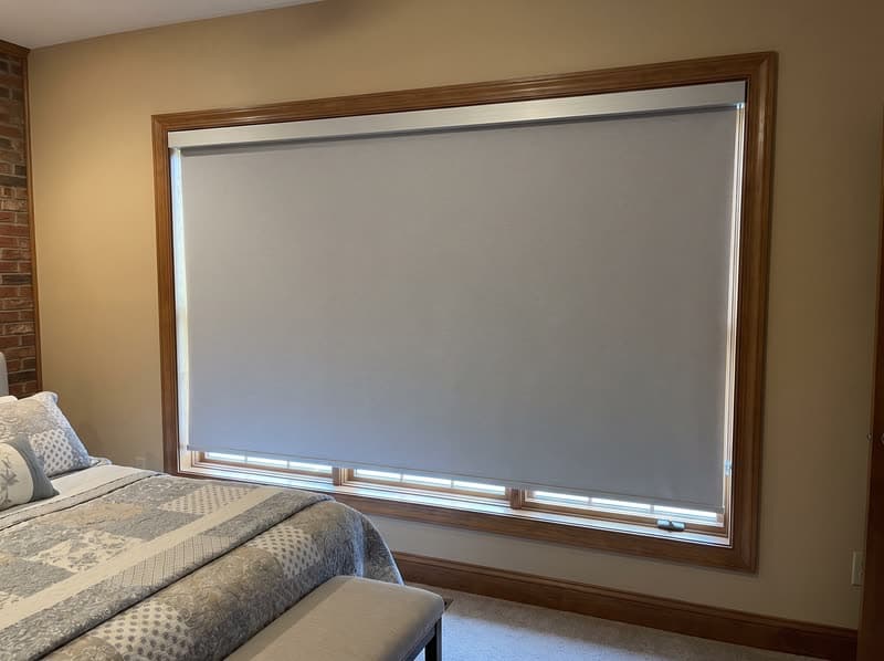 Roller shade on a guest bedroom window in a 1990s brick colonial in Woodstock