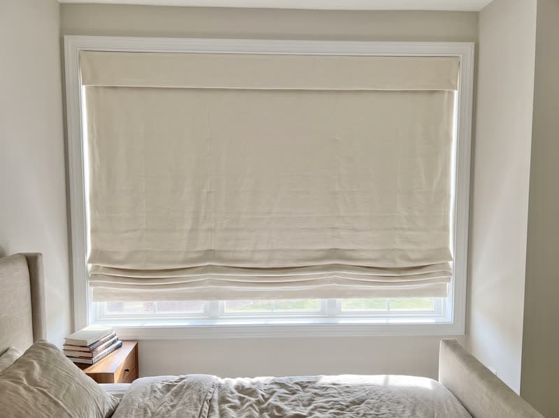 Roman shade on a primary bedroom window in a new build in a modern subdivision in Cumming