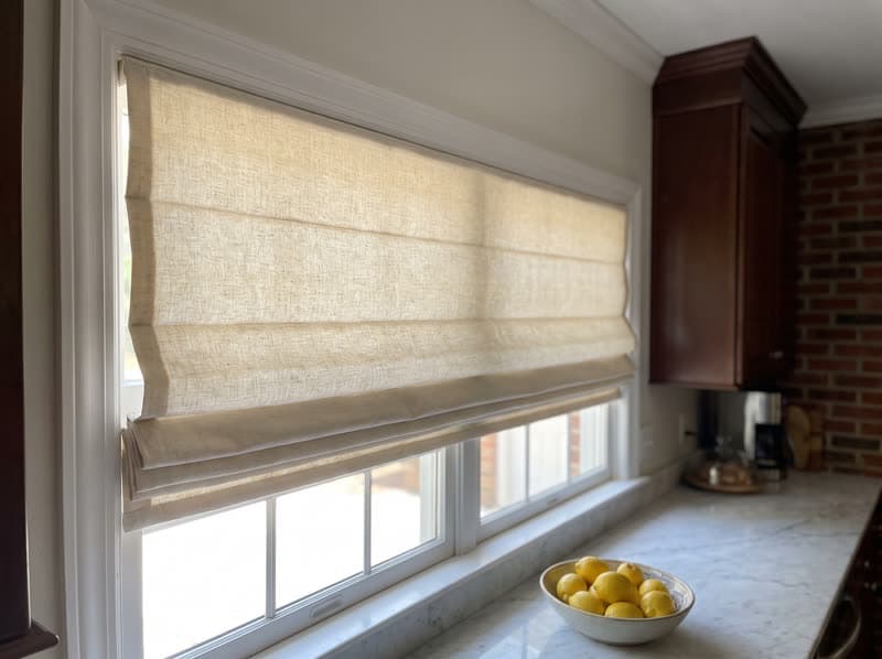 Roman shade on a kitchen window in a 1990s brick colonial in Alpharetta