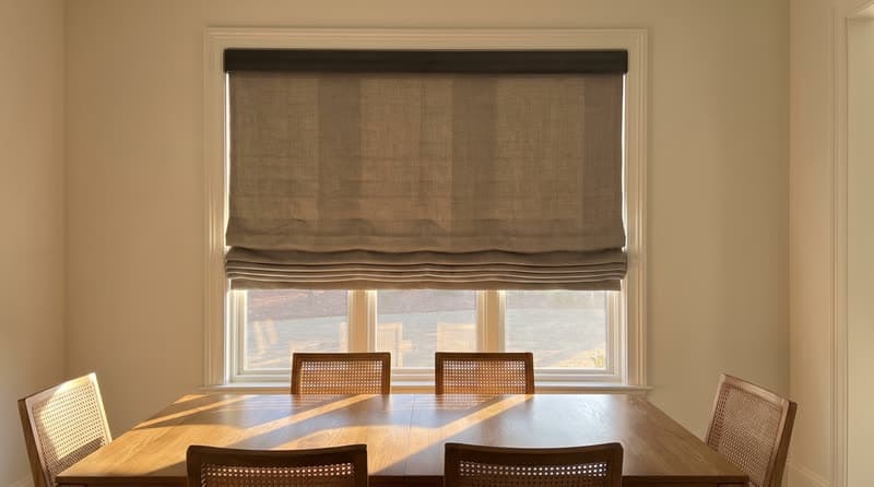 Roman shade on a dining room window in a luxury modern villa in Roswell