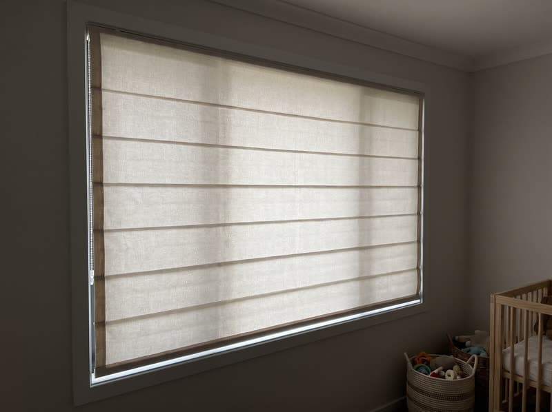 Roman shade on a nursery window in a new build in a modern subdivision in Suwanee