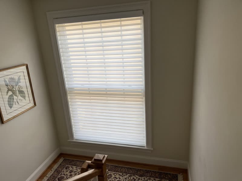 Shangri-La sheer shade on a stairwell landing window in a traditional two-storey house in Buford