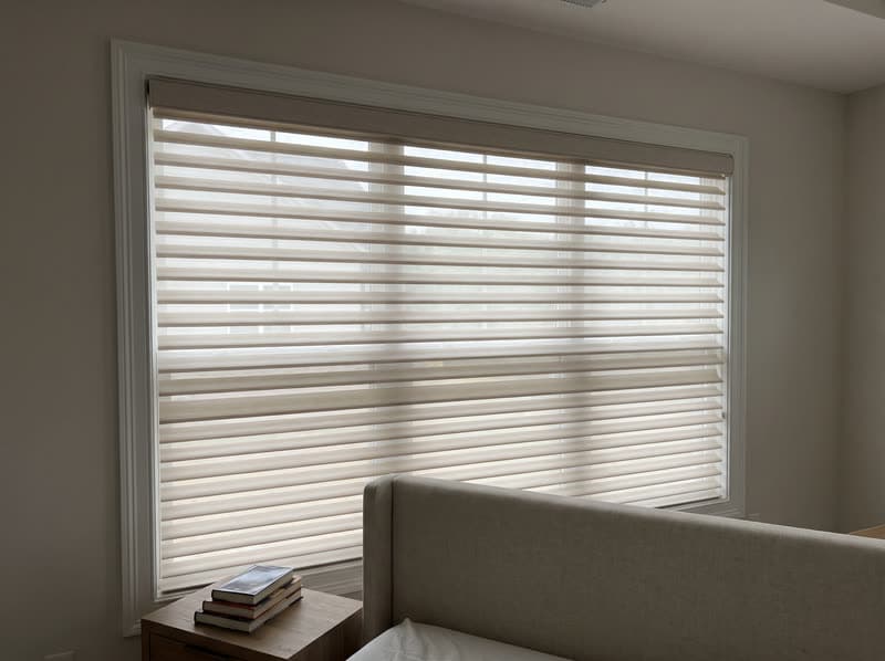 Shangri-La sheer shade on a primary bedroom window in a new build in a modern subdivision in Cumming