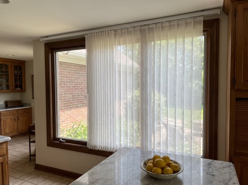 Dream curtain vertical sheer on a kitchen window in a 1990s brick colonial in Alpharetta